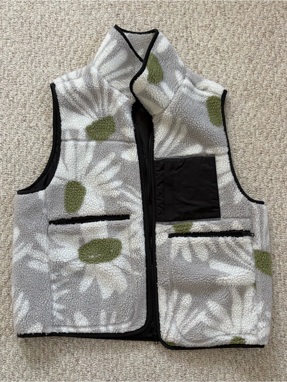 Grey fleece vest with white and green flowers